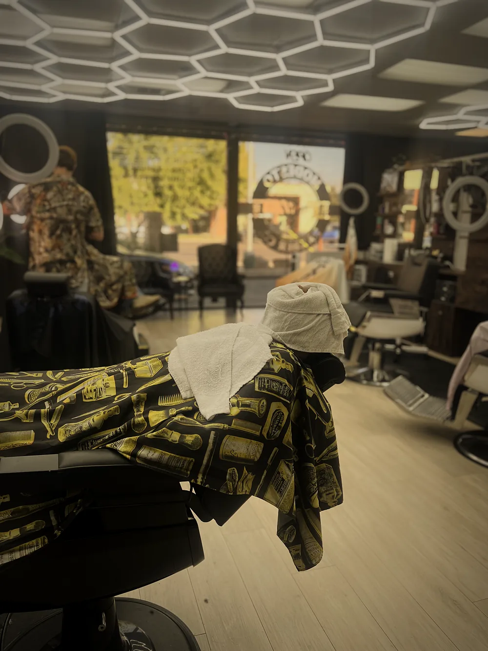Client relaxing under a hot towel shave at Modesto Barber Co.